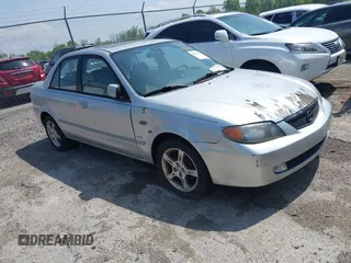 2003 Mazda Protege DX z VIN JM1BJ225430131527, wystawiony jako IAAI lot #42144261 z przebiegiem 215 988 mil mil oraz . Historia ofert i sprzedaży dostępna na DreamBid. Obrazek 1.