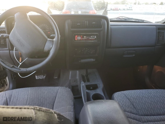 1999 Jeep Cherokee Sport with VIN 1J4FT68S6XL578679, listed as a Copart auction lot 76697394 with 196,110 mi miles and Salvage Title. Bid and sale history available at carsss.com. Image 8.