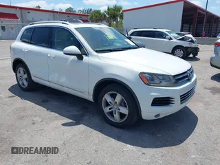 2012 Volkswagen Touareg Sport with VIN WVGEF9BP1CD008717, listed as a IAAI auction lot 42120641 with 211,580 mi miles and . Bid and sale history available at DreamBid. Image 1.