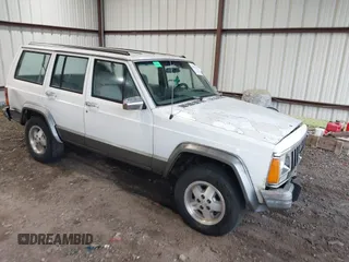 1991 Jeep Cherokee z VIN 1J4FJ58S0ML593142, wystawiony jako IAAI lot #40894329 z przebiegiem 289 321 mil mil oraz . Historia ofert i sprzedaży dostępna na DreamBid. Obrazek 1.