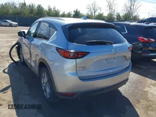 2021 Mazda CX-5 Grand Touring with VIN JM3KFBDM3M1300316, listed as a IAAI auction lot 41878520 with 77,670 mi miles and . Bid and sale history available at DreamBid. Image 3.
