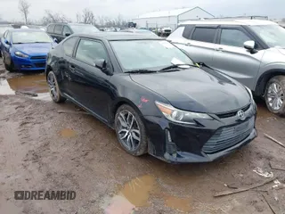 2014 Scion tC with VIN JTKJF5C74E3069104, listed as a IAAI auction lot 41579797 with 130,668 mi miles. Bid and sale history available at carsss.com. Image 1.