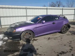 2006 Hyundai Tiburon GT z VIN KMHHN65FX6U225768, wystawiony jako Copart lot #88152475 z przebiegiem 243 072 mil mil oraz Szkody całkowita. Historia ofert i sprzedaży dostępna na DreamBid. Obrazek 1.
