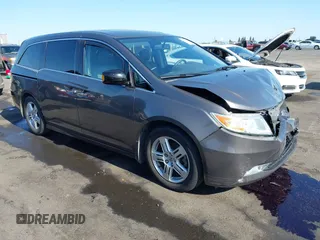 2012 Honda Odyssey Touring with VIN 5FNRL5H95CB057346, listed as a IAAI auction lot 42644094 with 114,712 mi miles and . Bid and sale history available at DreamBid. Image 1.