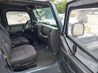 2002 Jeep Wrangler X with VIN 1J4FA39S92P736825, listed as a IAAI auction lot 42156410 with 196,313 mi miles. Bid and sale history available at carsss.com. Image 5.