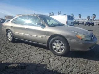2003 Ford Taurus SEL Deluxe with VIN 1FAFP56S23G221922, listed as a Copart auction lot 79673294 with 142,911 mi miles and Salvage Title. Bid and sale history available at DreamBid. Image 4.