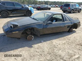 1985 Pontiac Fiero z VIN 1G2PM37R0FP243885, wystawiony jako Copart lot #43140515 z przebiegiem 179 713 mil mil oraz Czysty tytuł • Clean title. Historia ofert i sprzedaży dostępna na DreamBid. Obrazek 1.