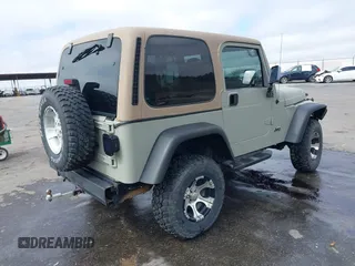 1999 Jeep Wrangler Sahara with VIN 1J4FY49S0XP480017, listed as a IAAI auction lot 41642577 with 154,068 mi miles. Bid and sale history available at carsss.com. Image 4.