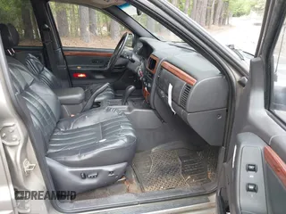 1999 Jeep Grand Cherokee Limited with VIN 1J4GW68N5XC684157, listed as a IAAI auction lot 42104283 with 164,506 mi miles. Bid and sale history available at carsss.com. Image 5.