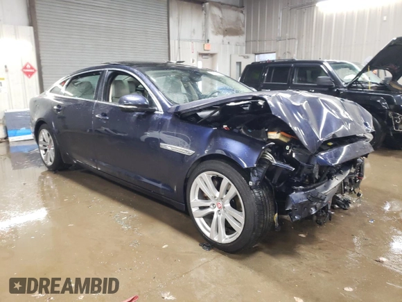 2014 Jaguar XJ Portfolio with VIN SAJWJ2GD5E8V69562, listed as a Copart auction lot 87737195 with 100,525 mi miles and Salvage title. Bid and sale history available at DreamBid. Image 4.