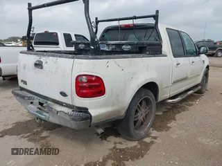 2002 Ford F-150 XLT with VIN 1FTRW07602KB74836, listed as a IAAI auction lot 42069307 with 295,692 mi miles. Bid and sale history available at carsss.com. Image 4.