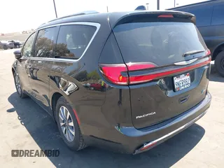 2021 Chrysler Pacifica Hybrid Touring L with VIN 2C4RC1L71MR599631, listed as a IAAI auction lot 42151965 with 67,401 mi miles and . Bid and sale history available at DreamBid. Image 3.