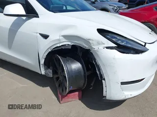 2020 Tesla Model Y Long Range with VIN 5YJYGDEE2LF058515, listed as a IAAI auction lot 41932748 with 62,885 mi miles and . Bid and sale history available at DreamBid. Image 6.