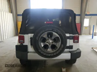 2016 Jeep Wrangler Unlimited Sahara with VIN 1C4BJWEGXGL310499, listed as a Copart auction lot 59756015 with 128,498 mi miles and Salvage title. Bid and sale history available at DreamBid. Image 6.
