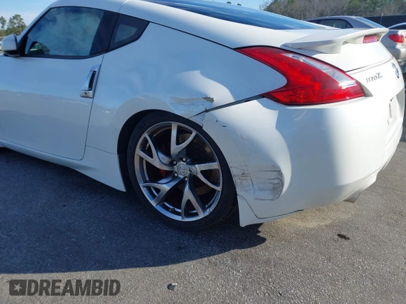 2013 Nissan 370Z z VIN JN1AZ4EH4DM380820, wystawiony jako IAAI lot #41547638 z przebiegiem 118 222 mil mil oraz . Historia ofert i sprzedaży dostępna na DreamBid. Obrazek 6.