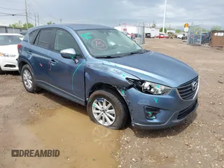 2016 Mazda CX-5 Touring z VIN JM3KE2CY3G0728968, wystawiony jako IAAI lot #42189174 z przebiegiem 145 977 mil mil oraz . Historia ofert i sprzedaży dostępna na DreamBid. Obrazek 1.