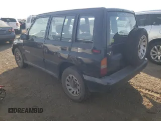 1998 Suzuki Sidekick JS z VIN 2S3TE02V1W6402490, wystawiony jako Copart lot #78316244 z przebiegiem 79 724 mil mil oraz Tytuł czysty. Historia ofert i sprzedaży dostępna na DreamBid. Obrazek 2.