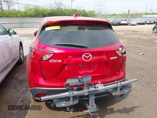 2014 Mazda CX-5 Touring with VIN JM3KE2CY4E0411780, listed as a IAAI auction lot 41903570 with 103,658 mi miles and . Bid and sale history available at DreamBid. Image 16.