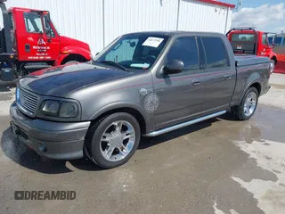 2002 Ford F-150 Harley Davidson with VIN 1FTRW07392KE11409, listed as a IAAI auction lot 41877998 with 148,476 mi miles. Bid and sale history available at carsss.com. Image 17.