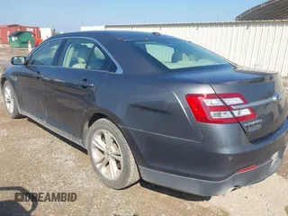 2015 Ford Taurus SEL z VIN 1FAHP2E80FG143819, wystawiony jako IAAI lot #42316114 z przebiegiem 103 959 mil mil oraz . Historia ofert i sprzedaży dostępna na DreamBid. Obrazek 3.