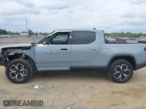 2023 Rivian R1T Adventure z VIN 7FCTGBAA6PN028520, wystawiony jako IAAI lot #42117498 z przebiegiem 24 583 mil mil oraz . Historia ofert i sprzedaży dostępna na DreamBid. Obrazek 15.