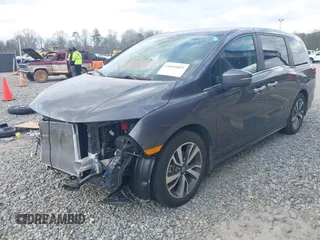 2023 Honda Odyssey Touring with VIN 5FNRL6H86PB065670, listed as a IAAI auction lot 41691093 with 22,518 mi miles and . Bid and sale history available at DreamBid. Image 2.