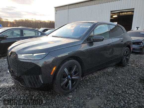 2022 BMW iX xDrive50 with VIN WB523CF05NCK62929, listed as a Copart auction lot 83295544 with 24,299 mi miles and Salvage Title. Bid and sale history available at carsss.com. Image 1.