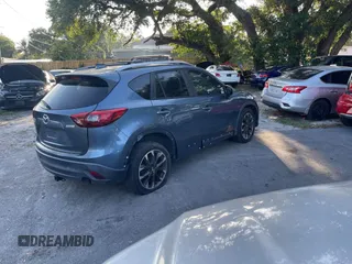 2016 Mazda CX-5 Grand Touring with VIN JM3KE4DY9G0673789, listed as a IAAI auction lot 42196841 with 98,622 mi miles and . Bid and sale history available at DreamBid. Image 4.