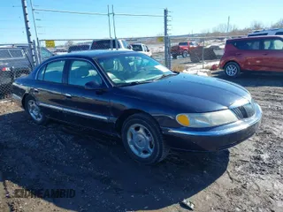 1999 Lincoln Continental with VIN 1LNHM97V8XY700644, listed as a IAAI auction lot 41641082 with 142,527 mi miles. Bid and sale history available at carsss.com. Image 1.
