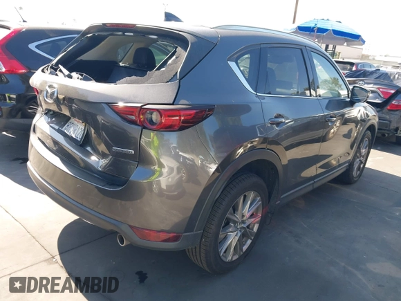 2020 Mazda CX-5 Grand Touring with VIN JM3KFADM3L1812649, listed as a IAAI auction lot 42575393 with 102,118 mi miles and . Bid and sale history available at DreamBid. Image 4.
