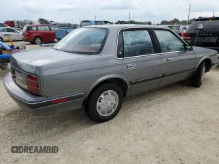 1992 Oldsmobile Cutlass z VIN 1G3AL54N4N6438104, wystawiony jako Copart lot #74415204 z przebiegiem 118 459 mil mil oraz Szkody całkowita. Historia ofert i sprzedaży dostępna na DreamBid. Obrazek 3.