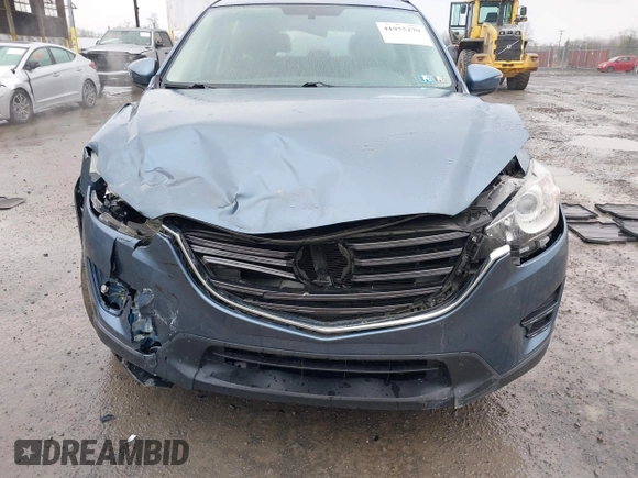 2016 Mazda CX-5 Sport with VIN JM3KE4BY5G0727608, listed as a IAAI auction lot 41975279 with 95,817 mi miles and . Bid and sale history available at carsss.com. Image 6.