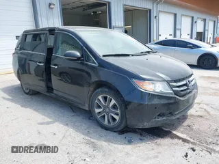 2014 Honda Odyssey Touring with VIN 5FNRL5H96EB099706, listed as a IAAI auction lot 42223135 with 237,072 mi miles and . Bid and sale history available at DreamBid. Image 1.