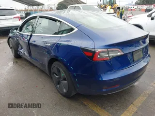 2020 Tesla Model 3 Standard Range Plus with VIN 5YJ3E1EAXLF644679, listed as a IAAI auction lot 41500595 with 53,726 mi miles and . Bid and sale history available at DreamBid. Image 3.
