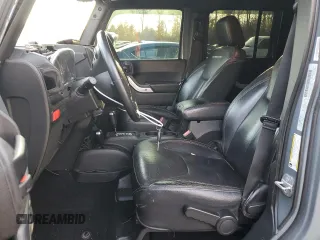 2015 Jeep Wrangler Unlimited Rubicon Hard Rock with VIN 1C4HJWFGXFL671660, listed as a Copart auction lot 82329074 with 214,579 mi miles and Salvage title. Bid and sale history available at DreamBid. Image 7.