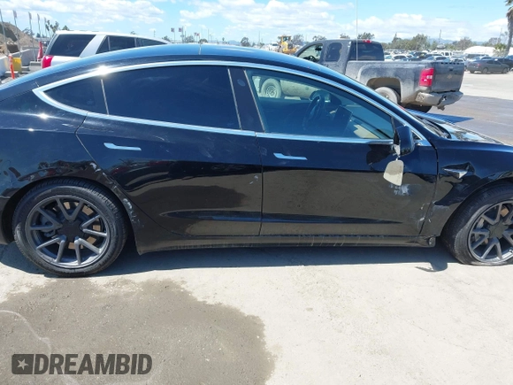 2019 Tesla Model 3 Mid Range with VIN 5YJ3E1EA3KF325056, listed as a IAAI auction lot 41771543 with 183,157 mi miles and . Bid and sale history available at carsss.com. Image 13.