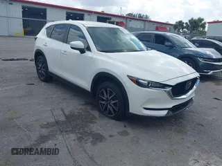 2018 Mazda CX-5 Touring z VIN JM3KFACM6J1419663, wystawiony jako IAAI lot #41879677 z przebiegiem 115 224 mil mil oraz . Historia ofert i sprzedaży dostępna na DreamBid. Obrazek 1.