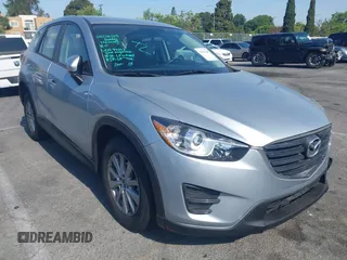 2016 Mazda CX-5 Sport z VIN JM3KE2BY4G0845816, wystawiony jako IAAI lot #42333248 z przebiegiem 48 504 mil mil oraz . Historia ofert i sprzedaży dostępna na DreamBid. Obrazek 1.