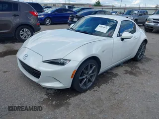 2020 Mazda MX-5 Miata Grand Touring z VIN JM1NDAM79L0411456, wystawiony jako IAAI lot #42229479 z przebiegiem 63 508 mil mil oraz . Historia ofert i sprzedaży dostępna na DreamBid. Obrazek 2.
