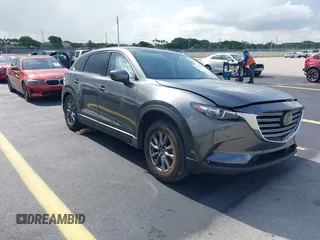 2021 Mazda CX-9 Touring z VIN JM3TCACY4M0511512, wystawiony jako IAAI lot #42376544 z przebiegiem 50 485 mil mil oraz . Historia ofert i sprzedaży dostępna na DreamBid. Obrazek 1.