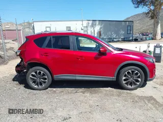 2016 Mazda CX-5 Grand Touring with VIN JM3KE2DY3G0686588, listed as a IAAI auction lot 41697312 with 65,090 mi miles. Bid and sale history available at carsss.com. Image 13.