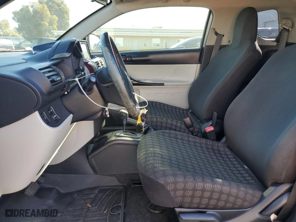 2012 Scion iQ with VIN JTNJJXB09CJ015632, listed as a Copart auction lot 79164024 with 87,075 mi miles and Salvage Title. Bid and sale history available at carsss.com. Image 7.
