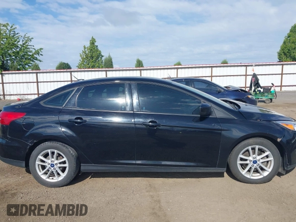 2018 Ford Focus SE z VIN 1FADP3F20JL288437, wystawiony jako IAAI lot #42278885 z przebiegiem 132 504 mil mil oraz . Historia ofert i sprzedaży dostępna na DreamBid. Obrazek 13.