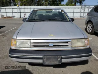 1989 Ford Tempo z VIN 1FAPP31X0KK113919, wystawiony jako Copart lot #76599314 z przebiegiem 65 823 mil mil oraz Tytuł czysty. Historia ofert i sprzedaży dostępna na DreamBid. Obrazek 11.