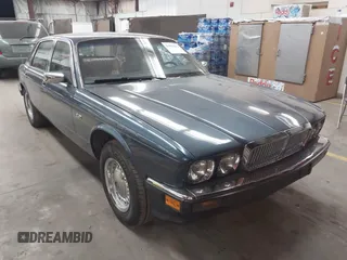 1989 Jaguar XJ with VIN SAJHY1542KC582957, listed as a IAAI auction lot 41826622 with 127,499 mi miles and . Bid and sale history available at DreamBid. Image 1.