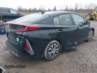2021 Toyota Prius LE with VIN JTDKAMFP2M3165859, listed as a IAAI auction lot 41943098 with 20,306 mi miles and . Bid and sale history available at DreamBid. Image 4.