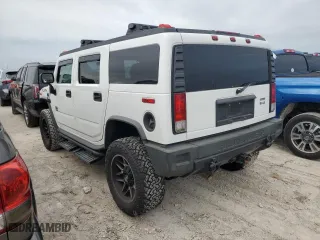 2005 Hummer H2 SUV with VIN 5GRGN23UX5H116341, listed as a Copart auction lot 76877704 with 145,778 mi miles and Salvage Title. Bid and sale history available at carsss.com. Image 2.