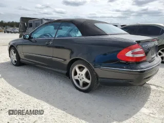 2004 Mercedes-Benz CLK 500 with VIN WDBTK75G04T005692, listed as a Copart auction lot 77038514 with 125,997 mi miles and Salvage Title. Bid and sale history available at DreamBid. Image 2.