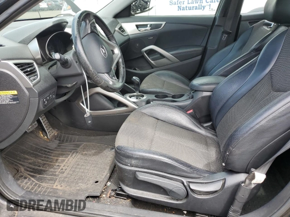 2013 Hyundai Veloster w/Gray Int z VIN KMHTC6AD9DU110094, wystawiony jako Copart lot #64660645 z przebiegiem 149 746 mil mil oraz Szkoda całkowita • Salvage title. Historia ofert i sprzedaży dostępna na DreamBid. Obrazek 7.