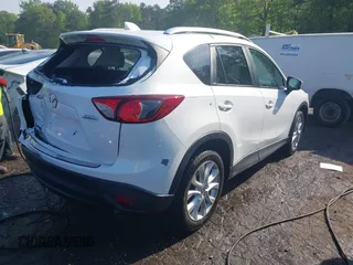 2014 Mazda CX-5 Grand Touring with VIN JM3KE2DY1E0424890, listed as a IAAI auction lot 42052437 with 107,793 mi miles. Bid and sale history available at carsss.com. Image 4.